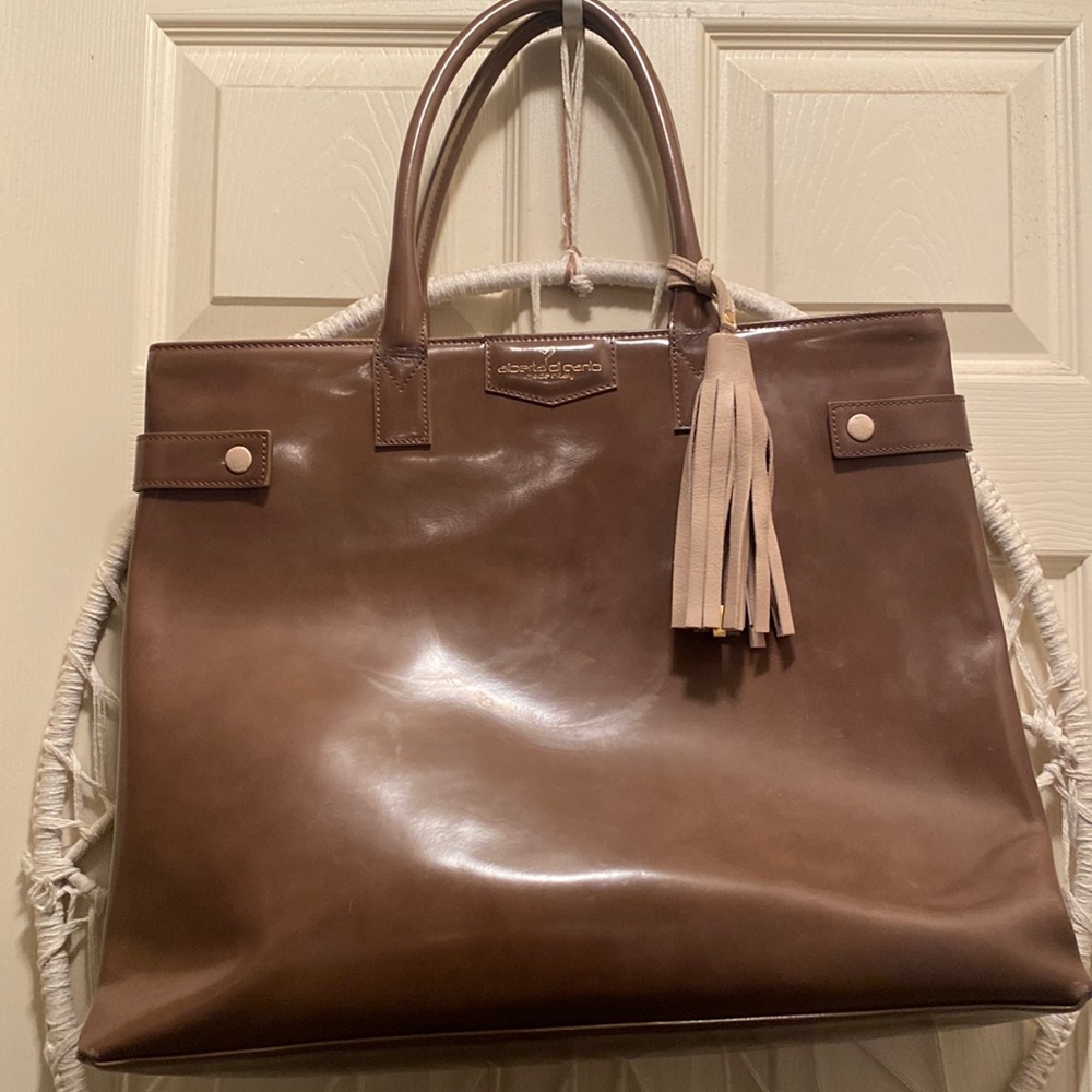 Genuine leather. Roomy. Inside pockets. Very gently used.